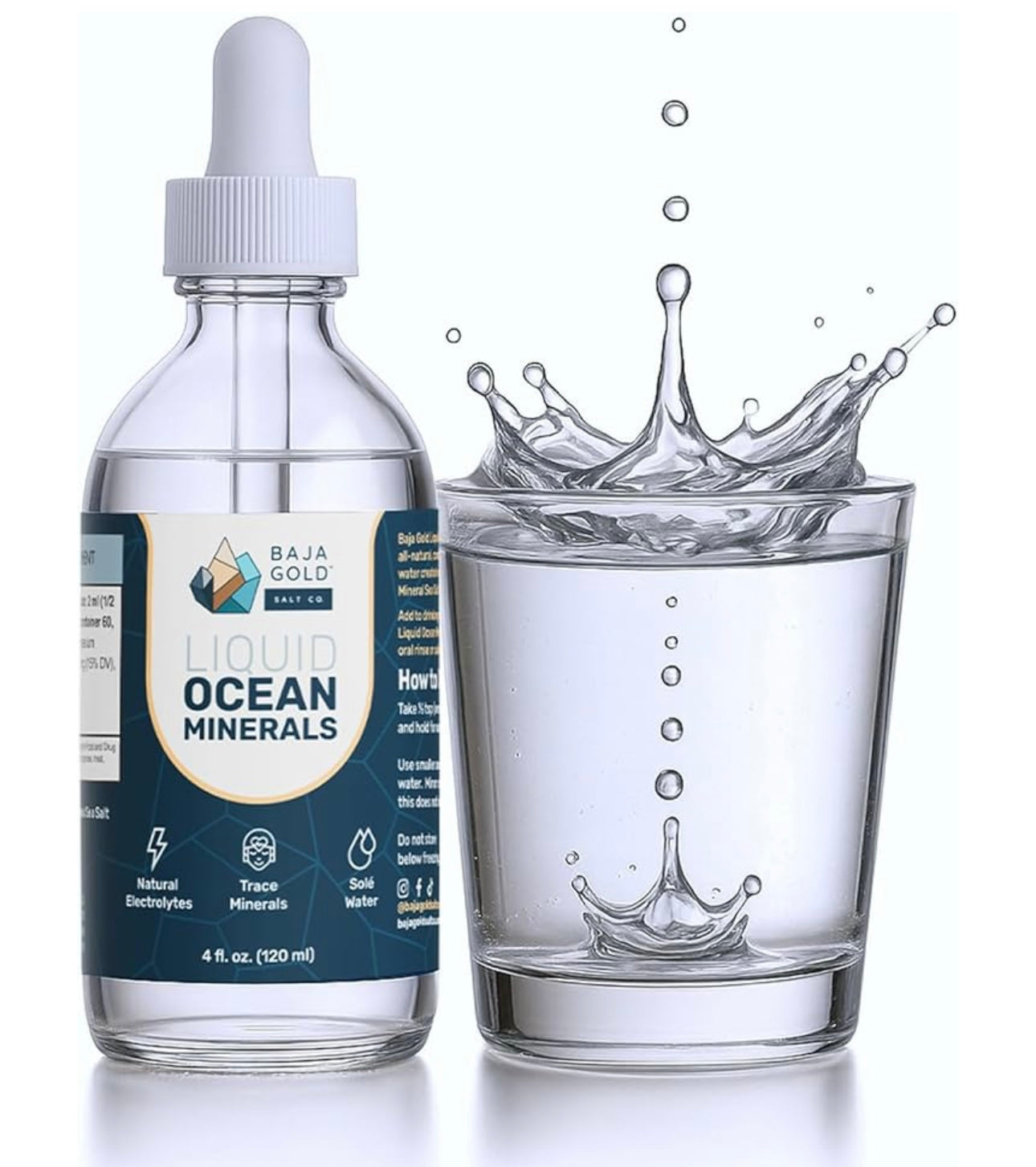 Bottle of Baja Gold Liquid Ocean Minerals with a glass of water splashing into it on a white background