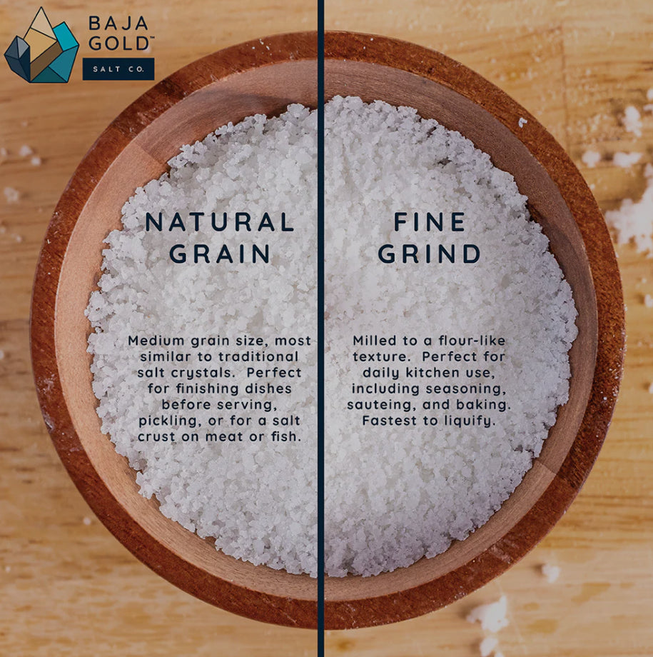 Bowl with natural grain and fine grind salt on a wooden surface, featuring Baja Gold Salt Co branding.