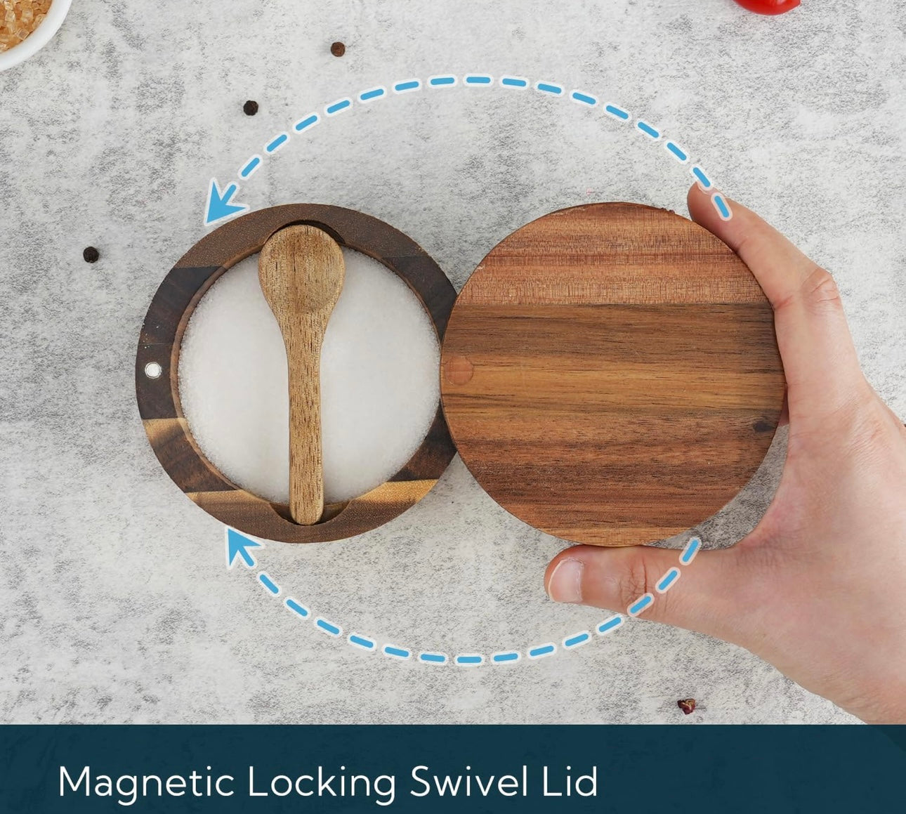 Wooden container with a magnetic locking swivel lid held by a hand on a gray surface.