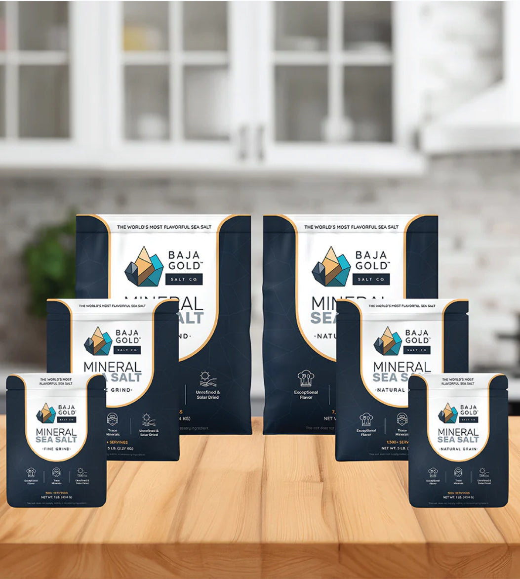 Baja Gold Mineral Sea Salt packages on a kitchen counter with blurred cabinets in the background