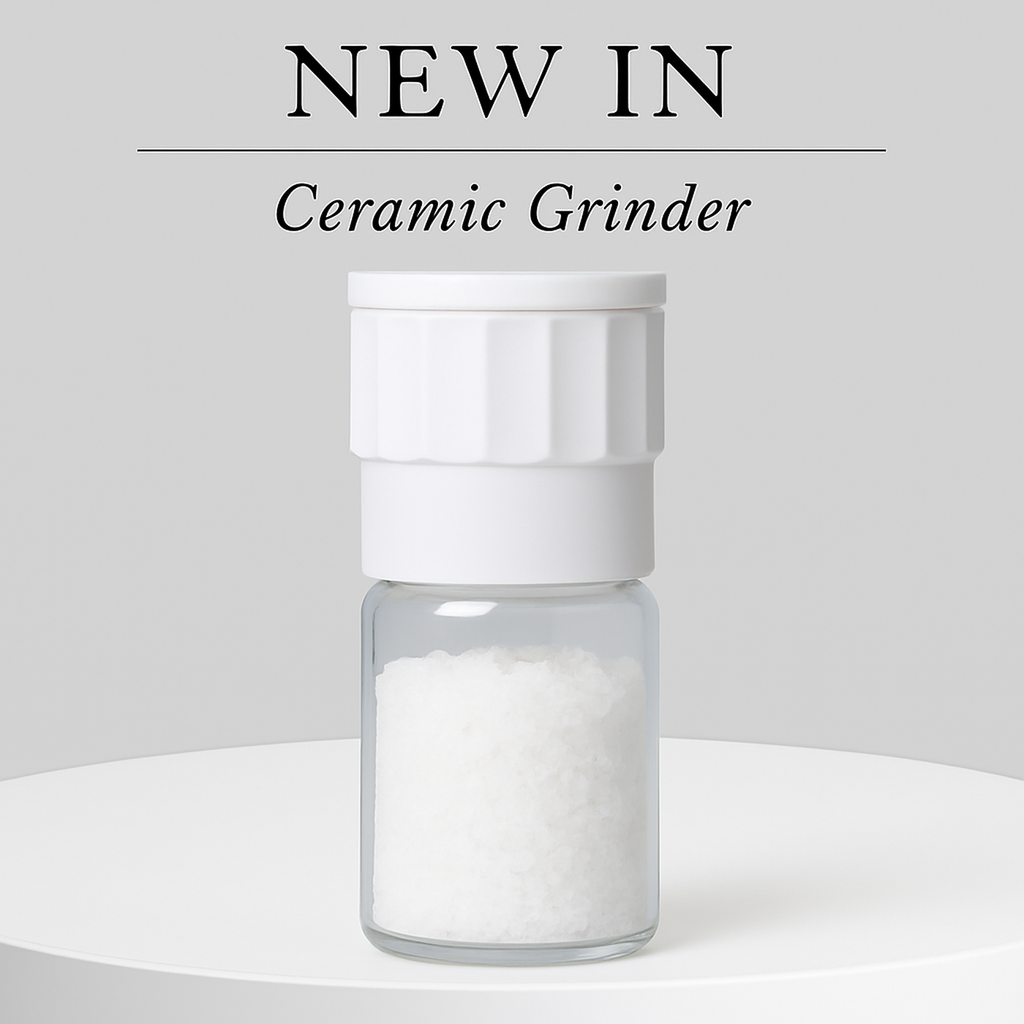 White ceramic grinder with clear container on a white background