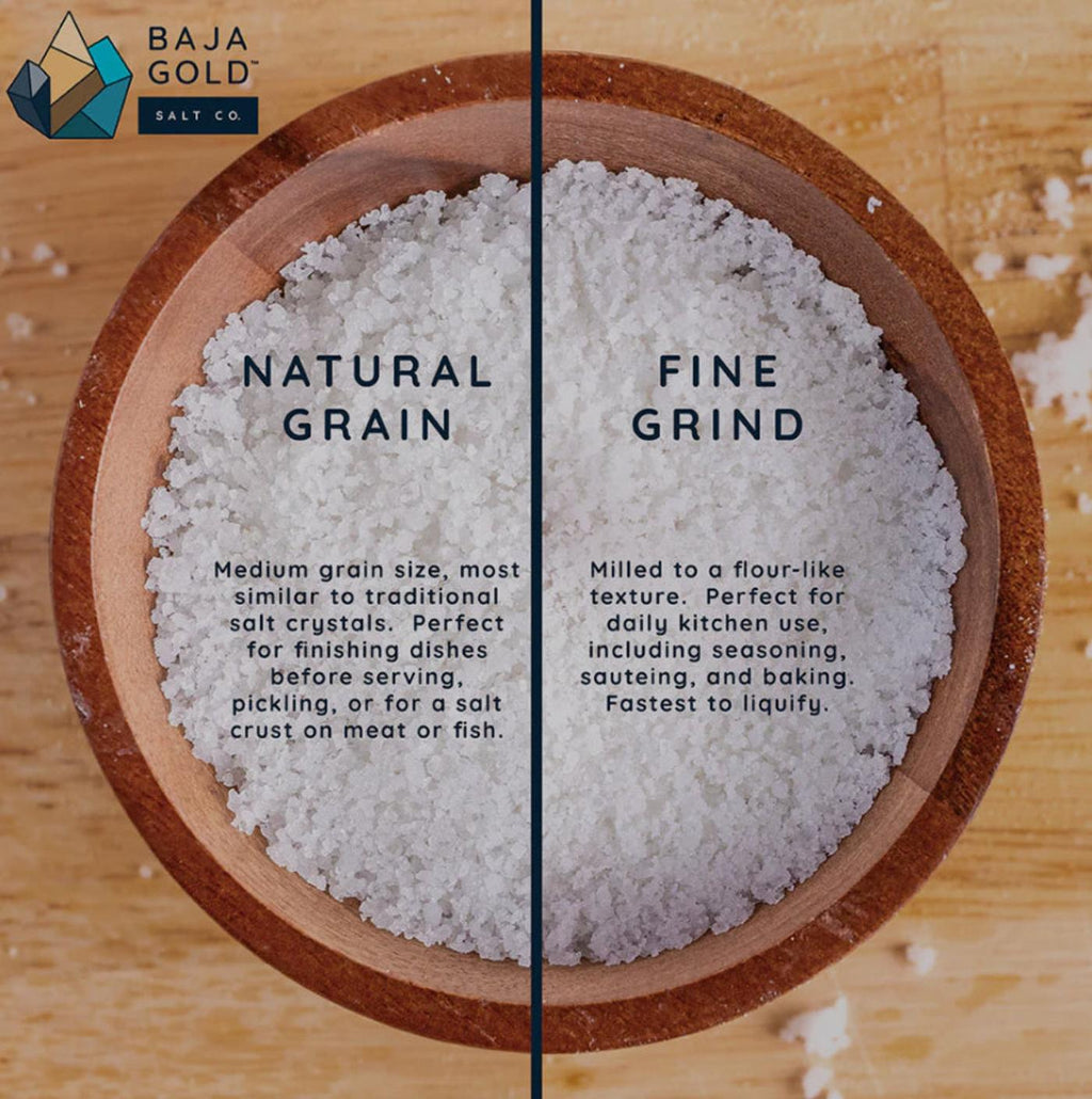 Bowl of Baja Gold Salt with natural grain and fine grind salt on a wooden surface, featuring Baja Gold Salt Co branding.