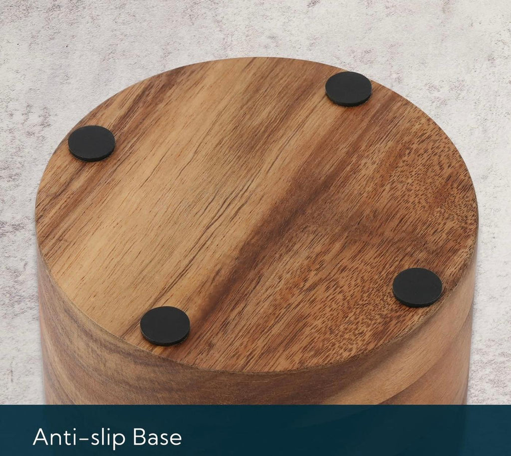 Wooden stool with anti-slip black circular pads on a light gray background
