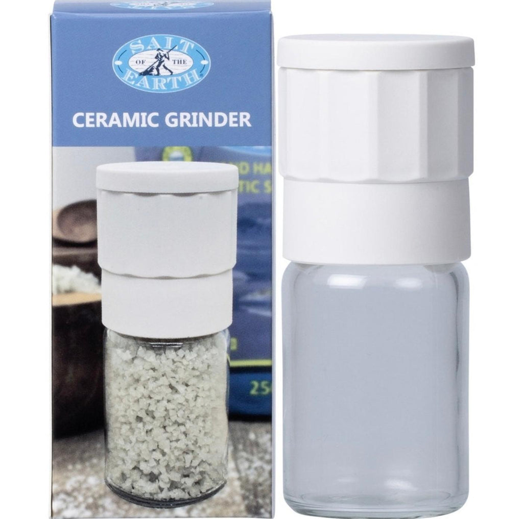 White ceramic grinder with clear container next to its packaging box.