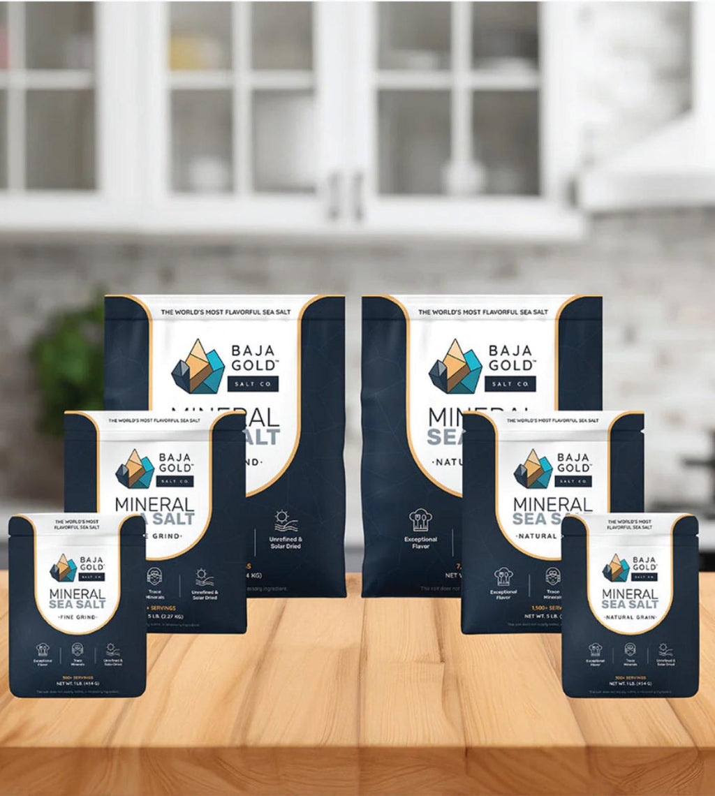 Baja Gold Mineral Sea Salt packages on a kitchen counter with blurred cabinets in the background