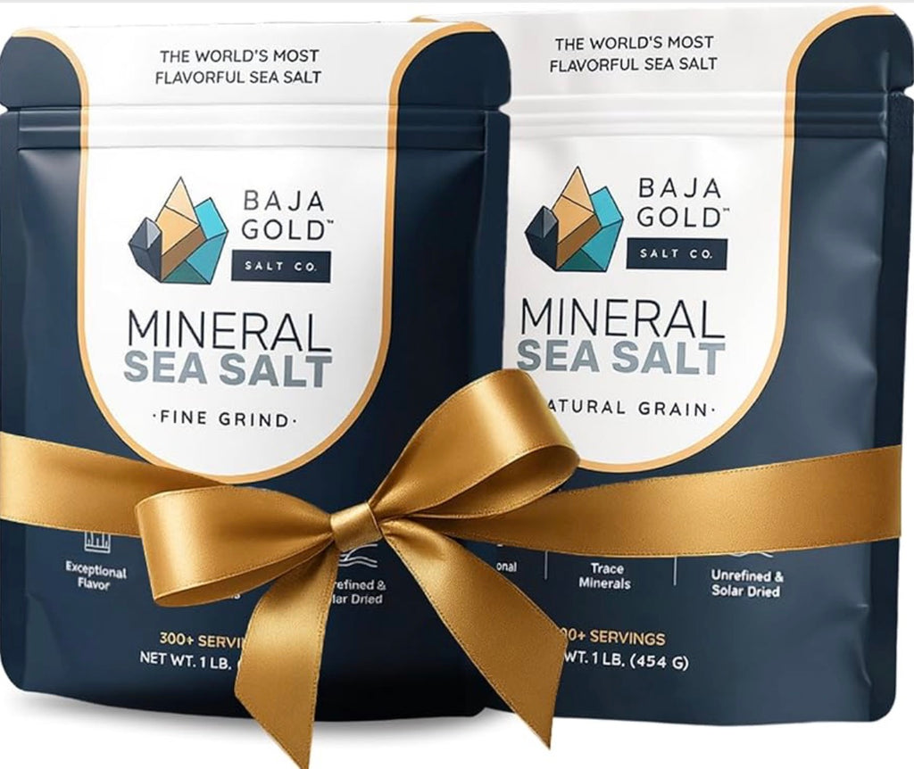 Two packages of Baja Gold Mineral Sea Salt with a gold ribbon on a white background