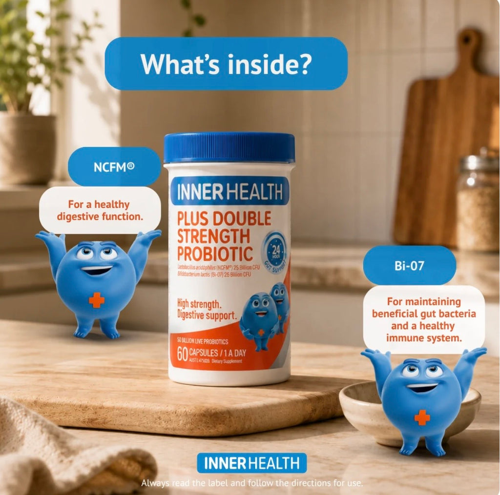 A bottle of INNER HEALTH Plus Double Strength Probiotic centered on a wooden cutting board, with two blue cartoon mascot characters and text callouts reading NCFM® and BI-07 in a kitchen setting.