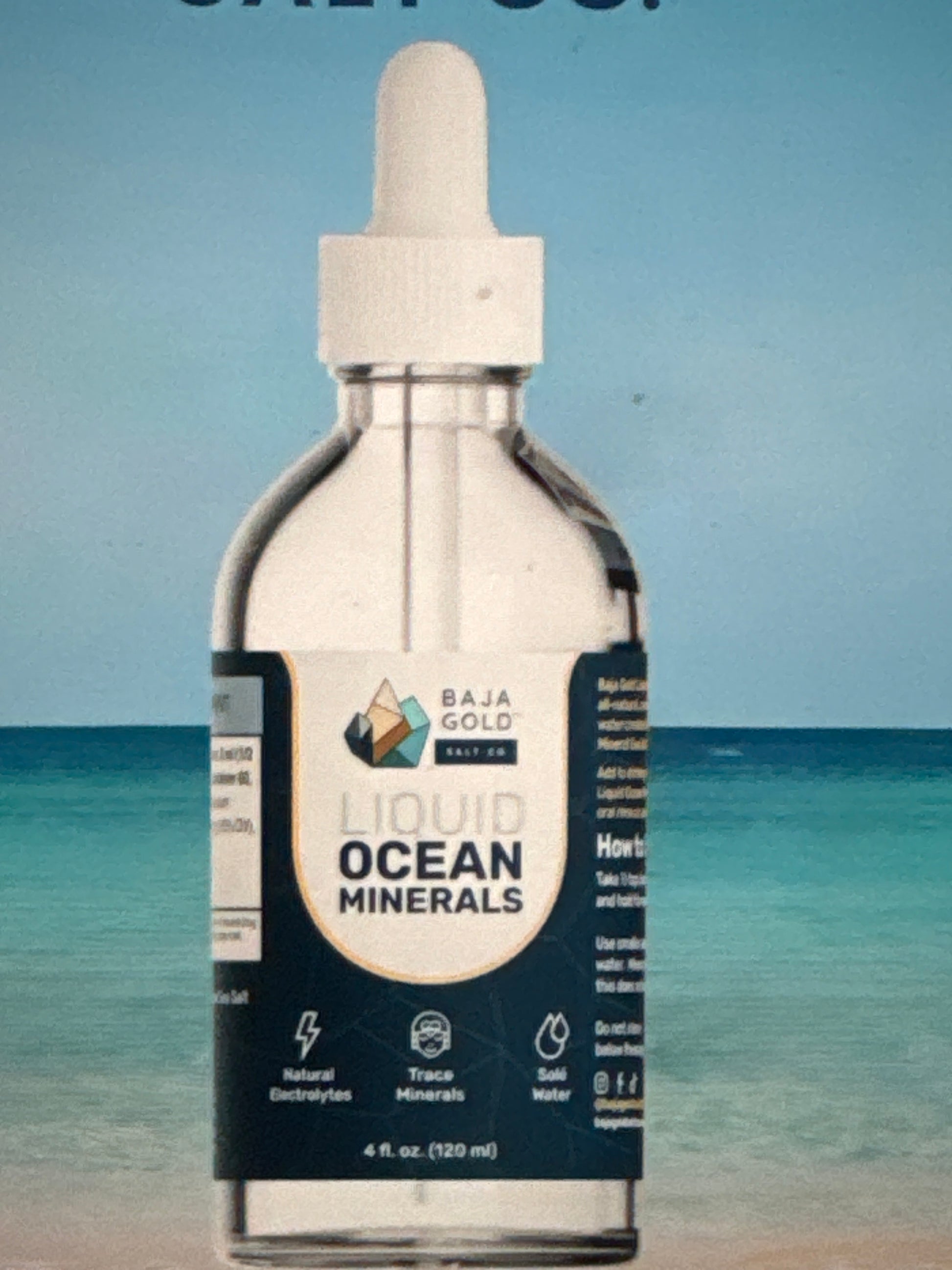 Bottle of Liquid Ocean Minerals with a blue gradient background